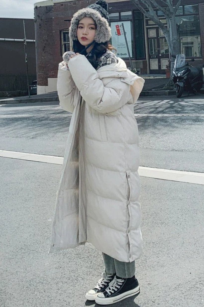 Long puffer winter coat, designed for warmth and style in cold weather.